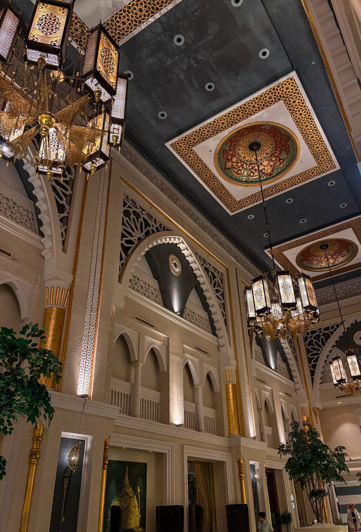 A grand hallway with a decorated ceiling and lanterns