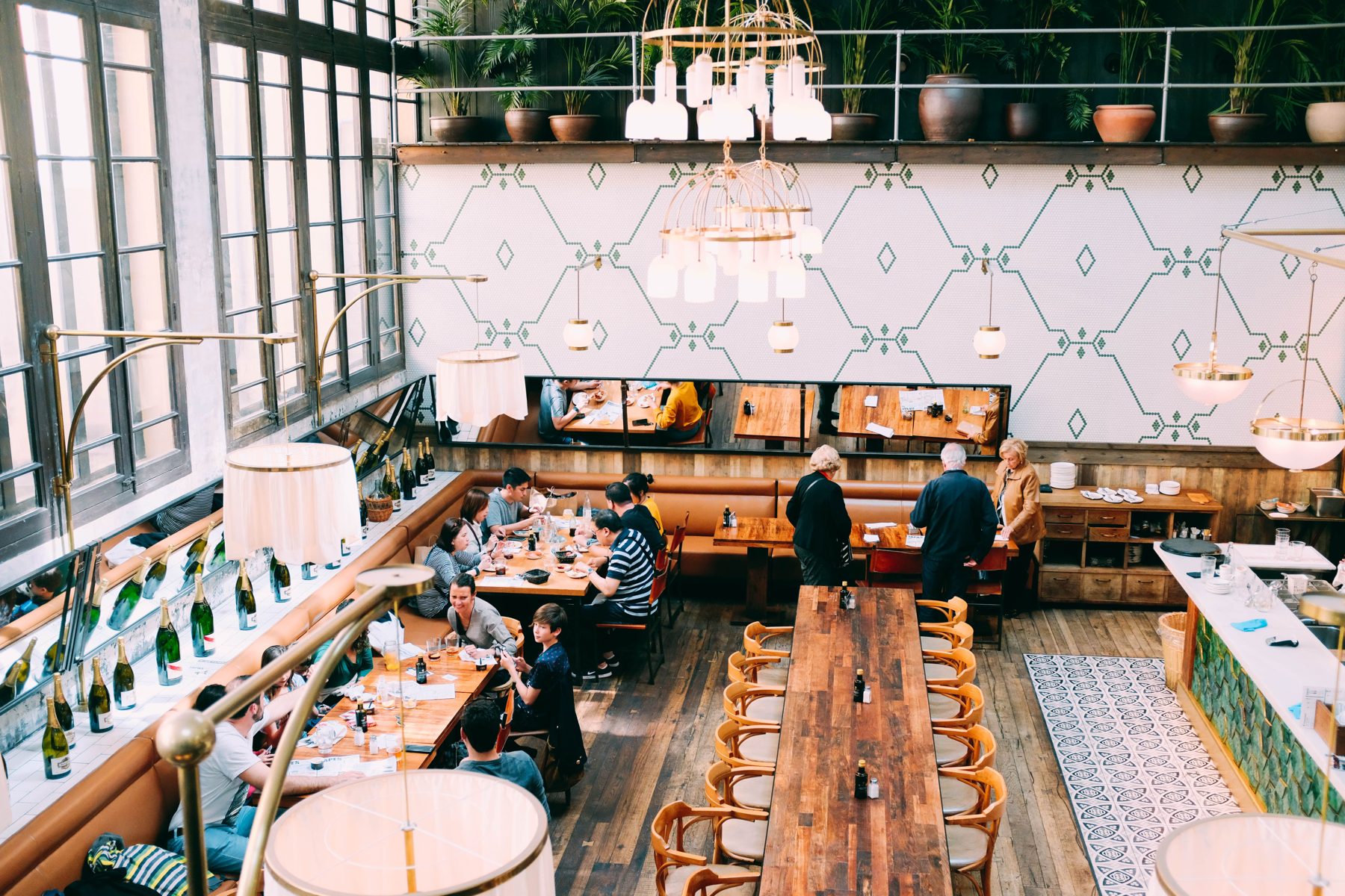 A bright dining room from above with one long timber table