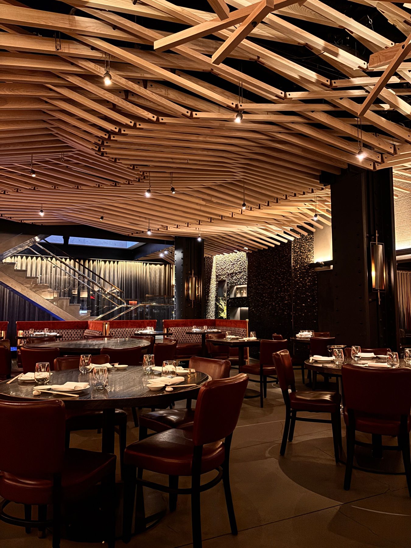 A warm room with a ceiling of woven timber slats