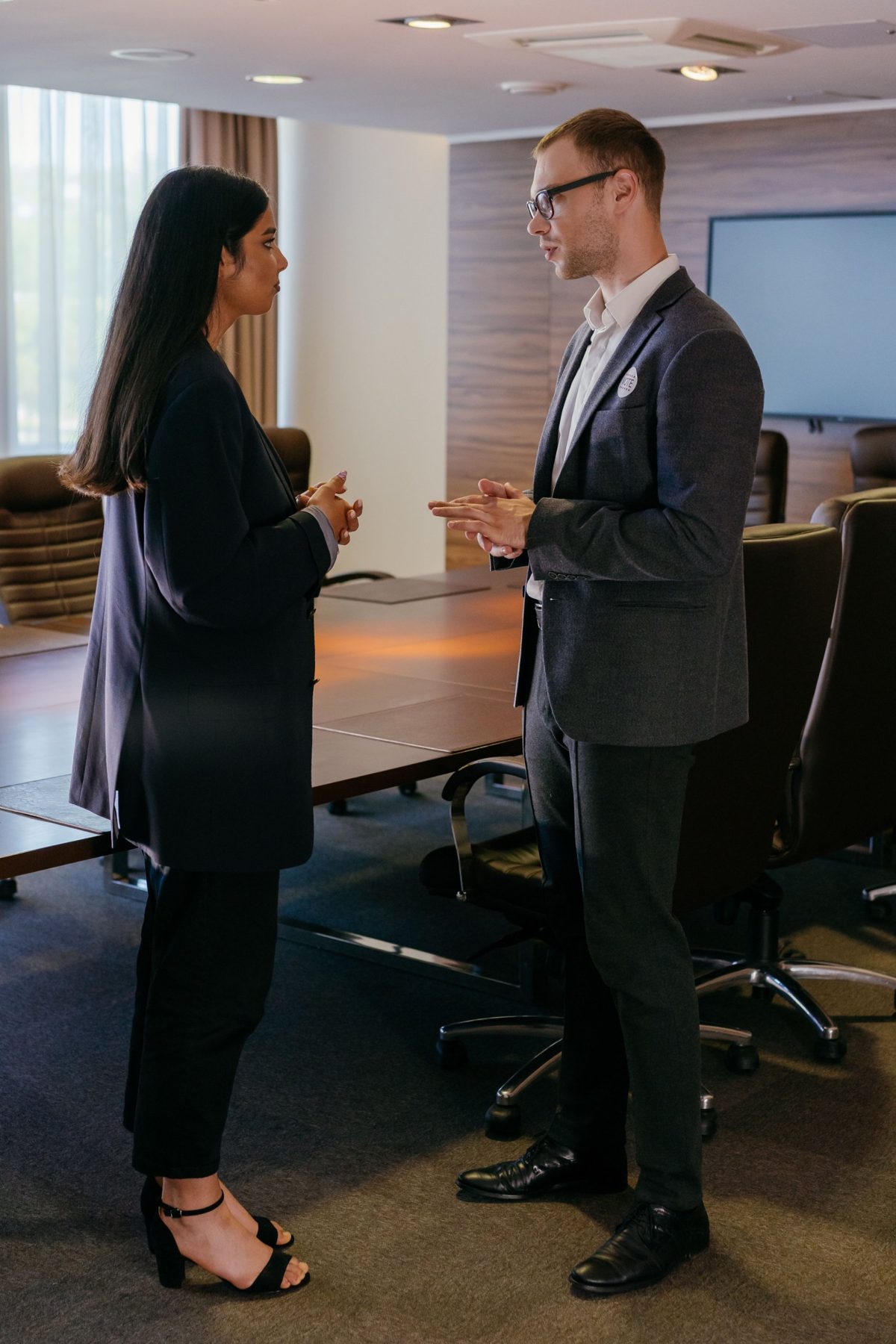 A solicitor and a client talking quietly in a meeting room