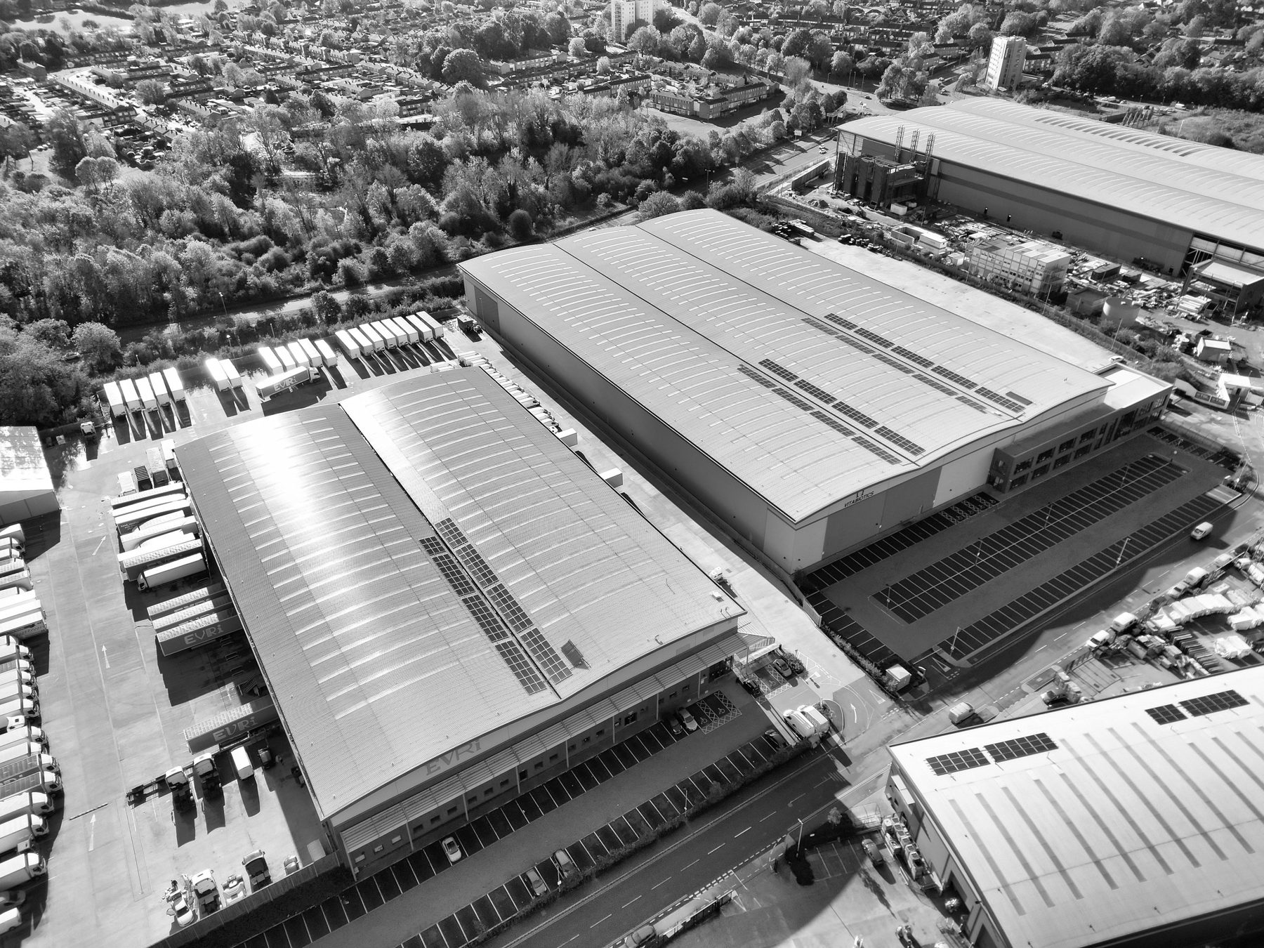 An aerial view of a large warehouse estate with grey roofs and yards
