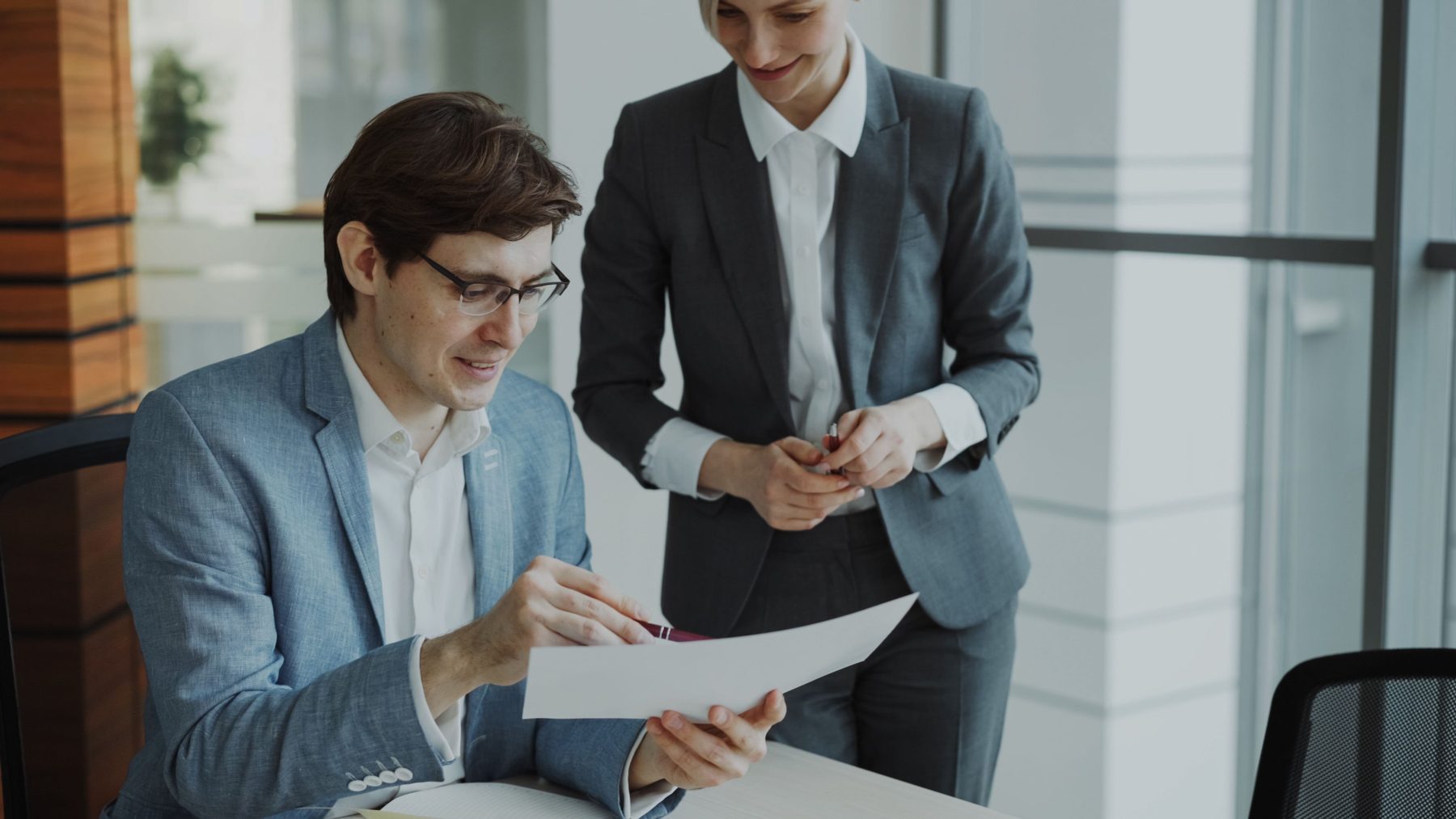 An adviser going through a mortgage document with a colleague